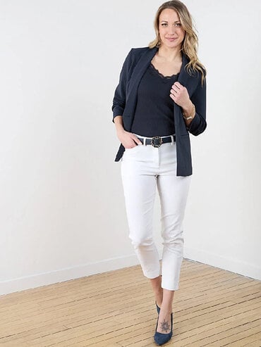 woman in white jeans and navy blazer