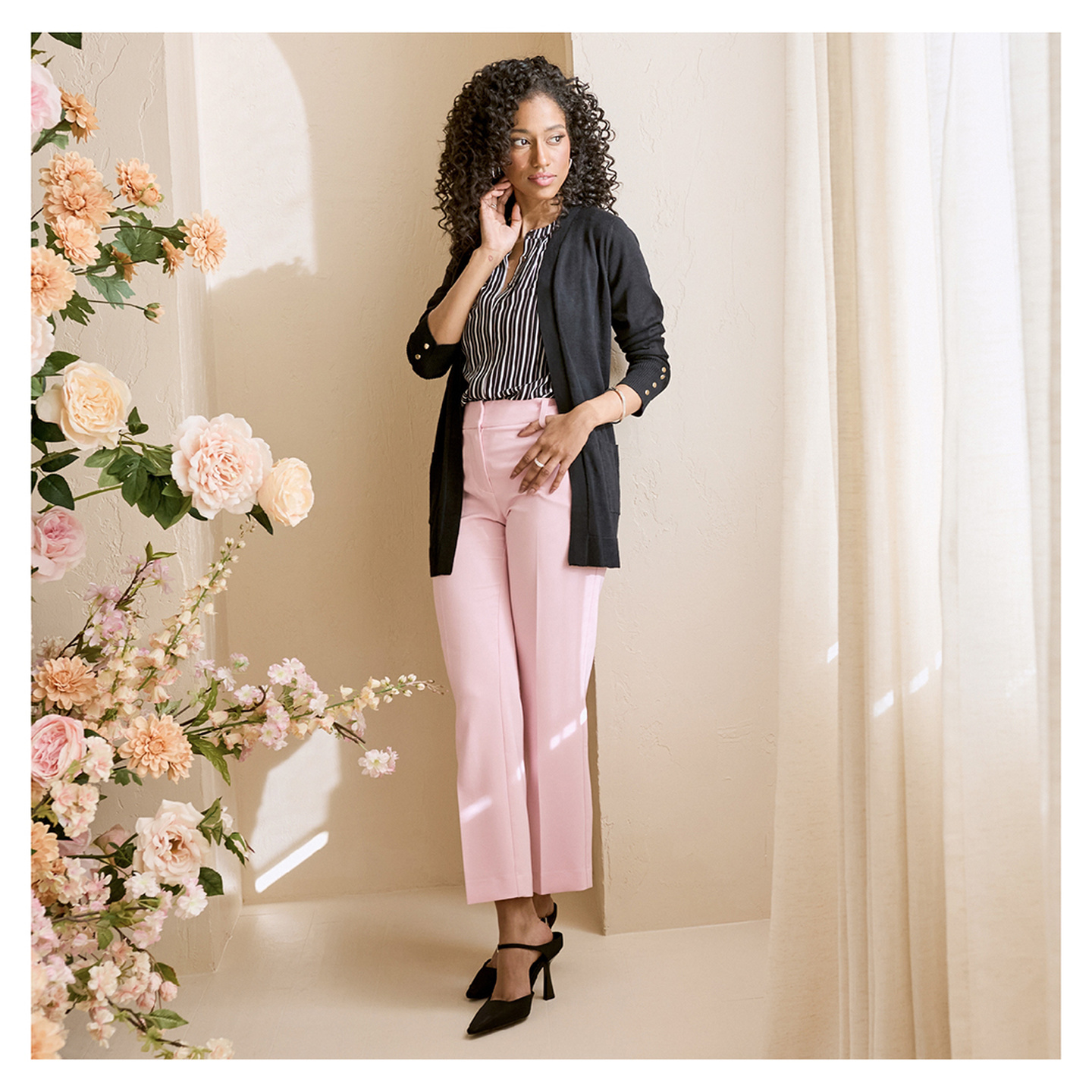 Model in Pink pants and black cardigan